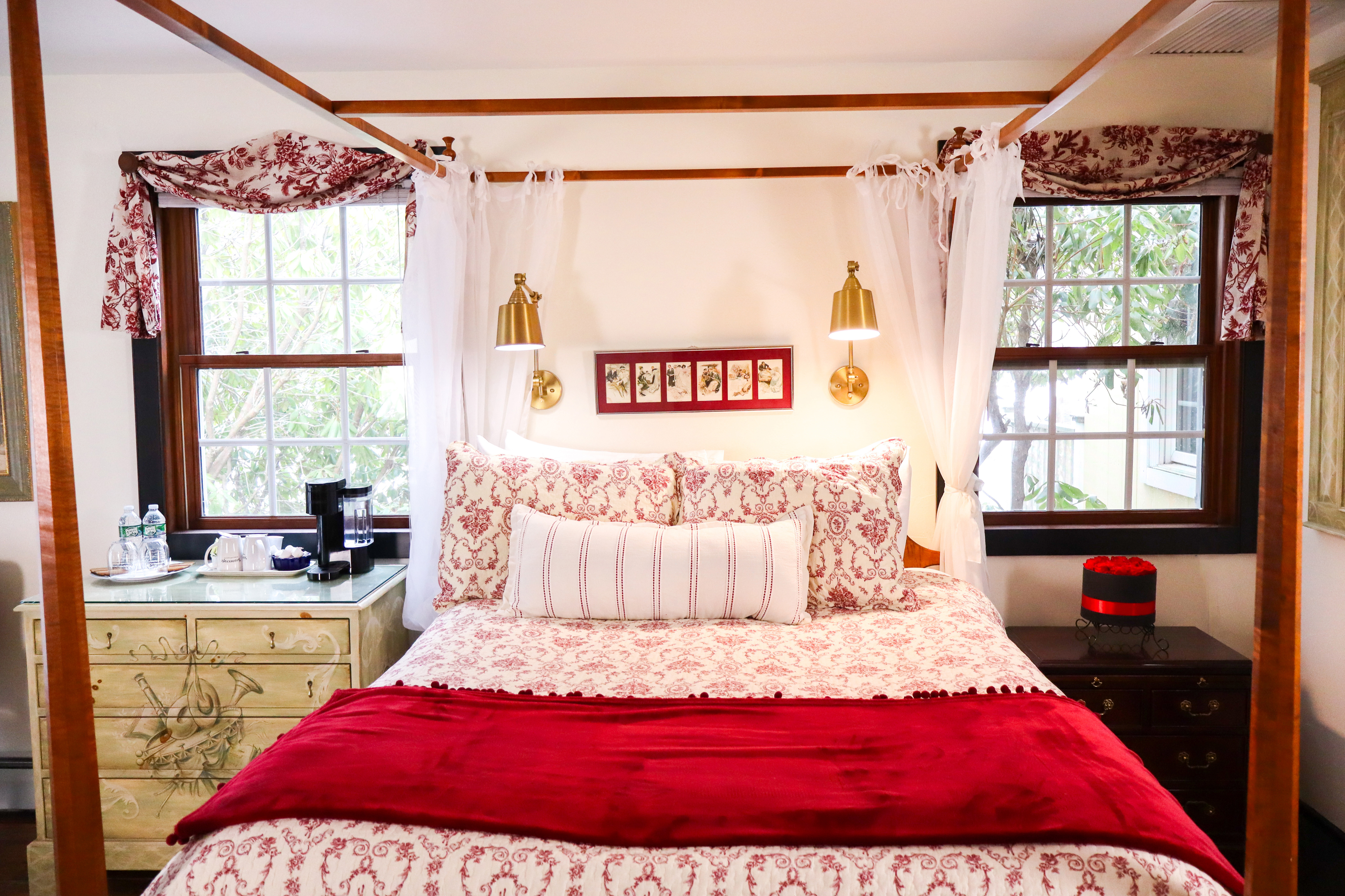 A bright, luxurious bathroom featuring a large jetted tub with a bath caddy and candles.