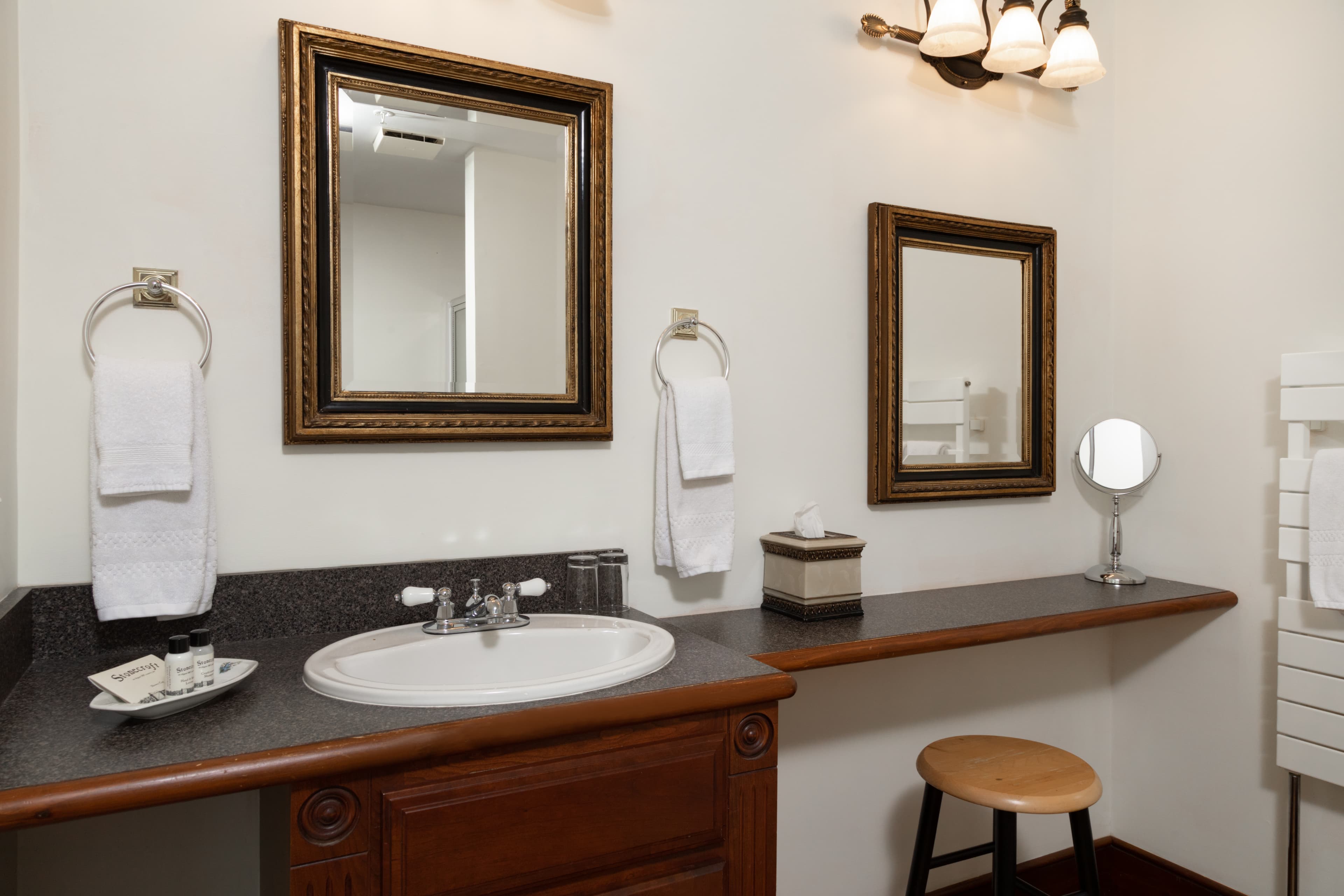 A vanity in a medium sized bathroom.