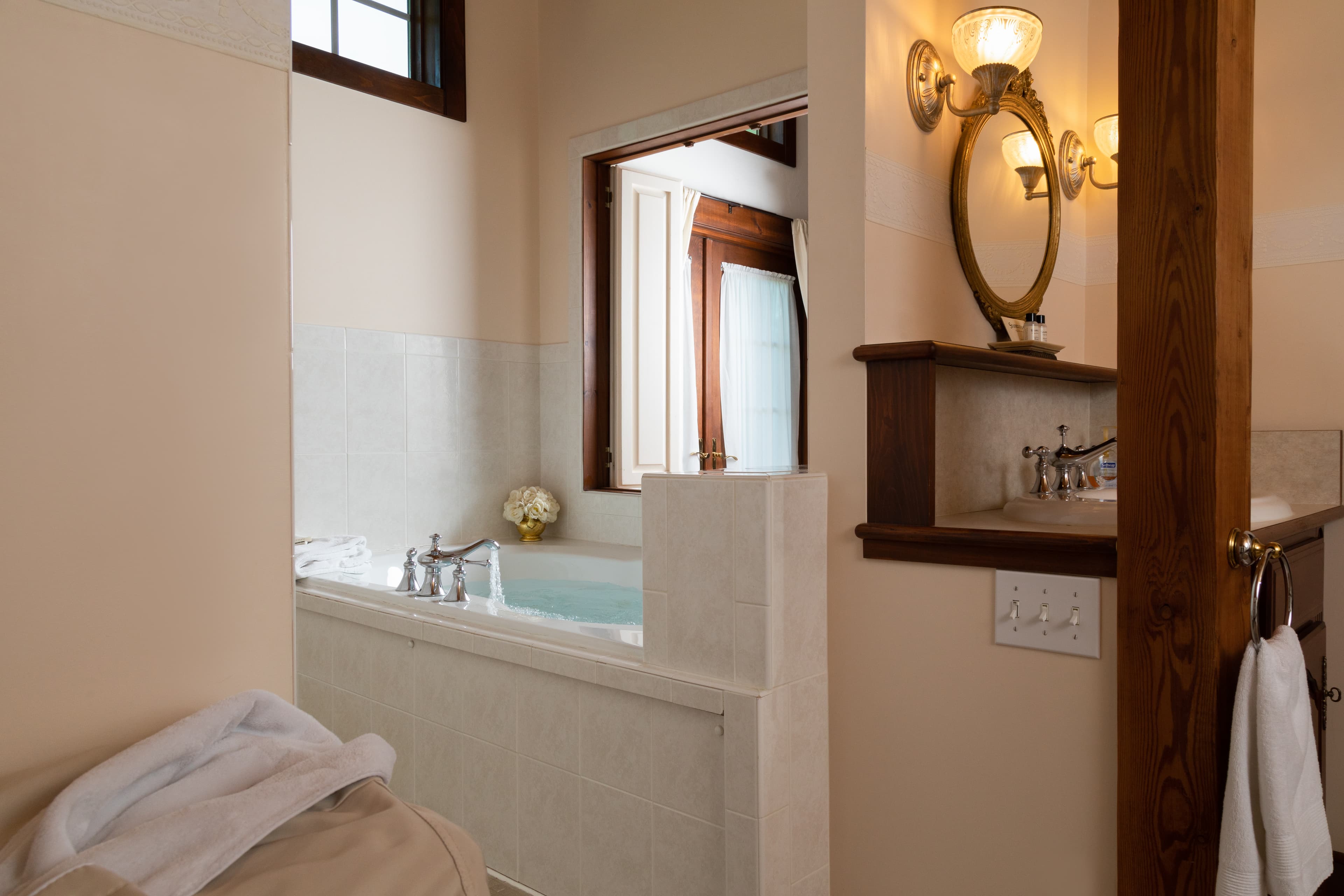 view of large jetted tub and a bright window