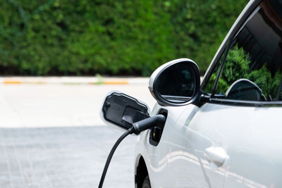 An electric vehicle is charging at a charging station.