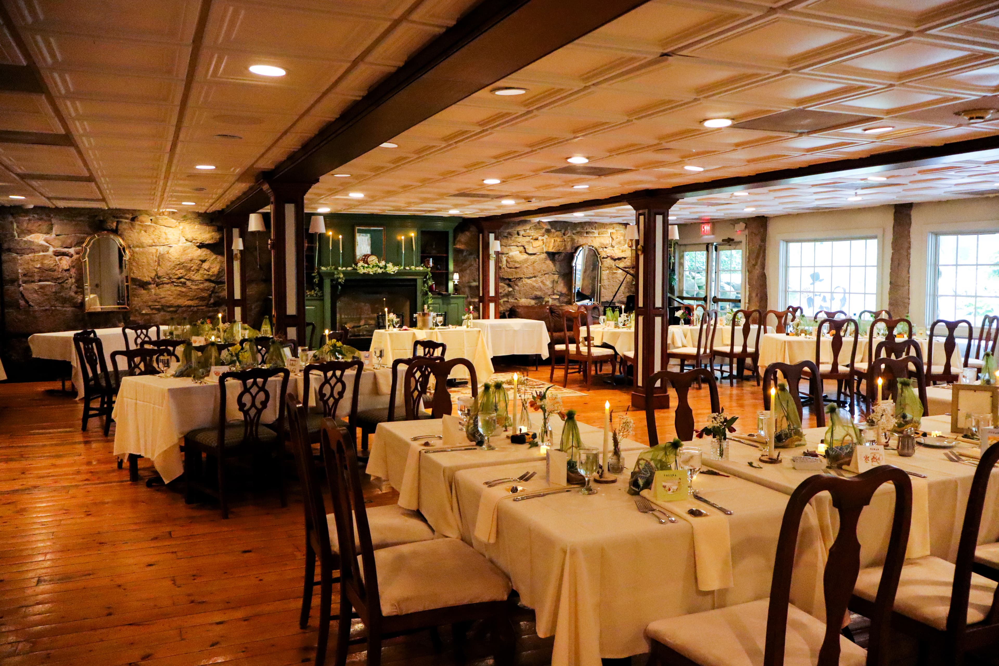 A cozy dining room featuring elegantly set tables with floral centerpieces.