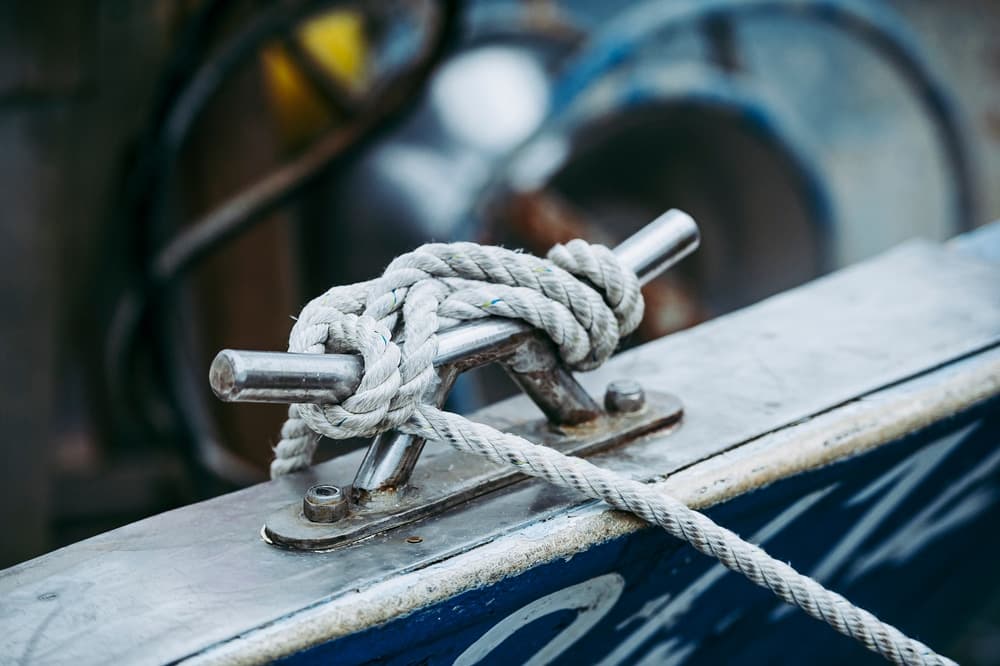 A knot tied to a metal cleat on a boat.