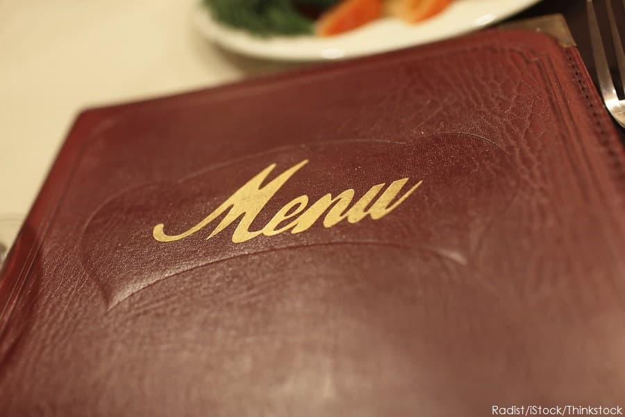 A close-up of a maroon menu cover with the word "Menu" embossed in gold.