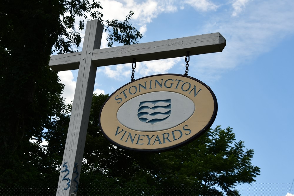 Sign for Stonington Vineyards, featuring waves and a blue sky background.