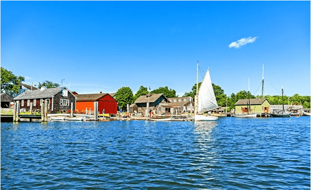 A scenic view of a harbor with sailboats and colorful buildings under a clear blue sky. A scenic view of a harbor with sailboats and colorful buildings under a clear blue sky.