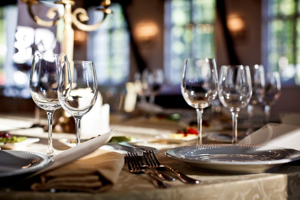 Elegant dining table set with sparkling glassware and fine china.