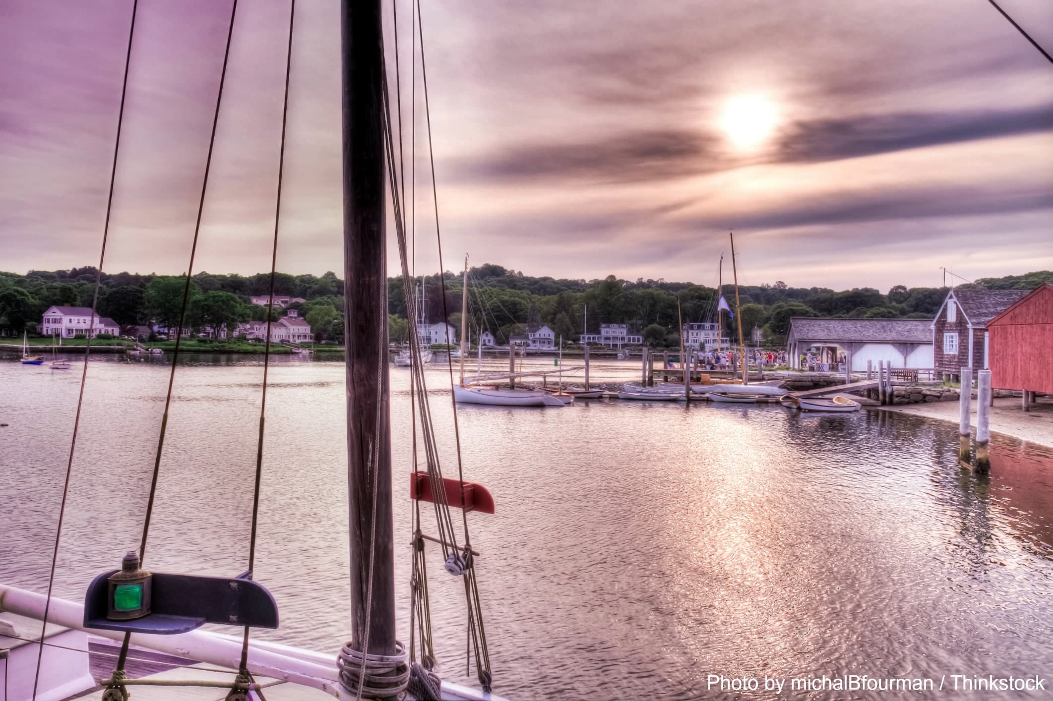 A peaceful marina at sunset, featuring sailboats and a scenic shoreline. A peaceful marina at sunset, featuring sailboats and a scenic shoreline.