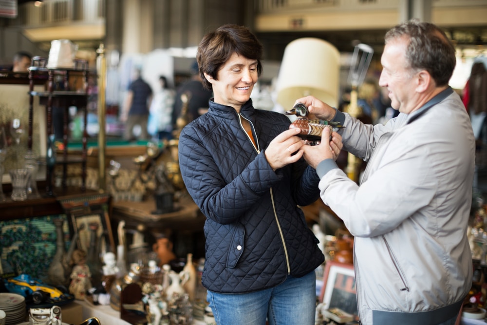 Connecticut Antique Shops near downtown Mystic, couple finding something they want to buy